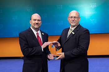ABF Freight's Bryan Swaim, vice president – pricing, treasurer & controller, (left) and Gary Hunt, vice president – equipment & maintenance, accept the 2018 SmartWay Freight Carrier Excellence Award. 