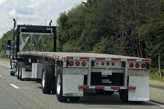 semi-truck pulling a flatbed trailer 
