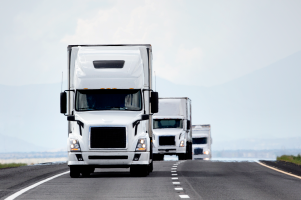 semi trucks on a highway hauling consolidated freight