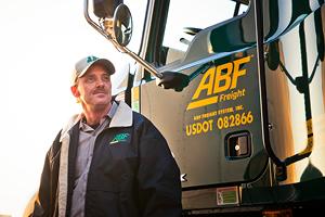 Driver standing in front of ABF Freight truck door