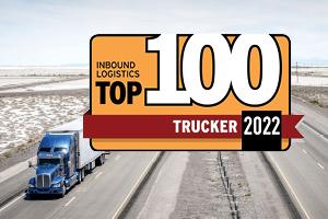 Truck driving down highway with top 100 banner