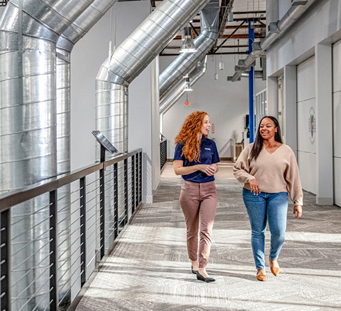 ArcBest employee walks down a hallway with a customer