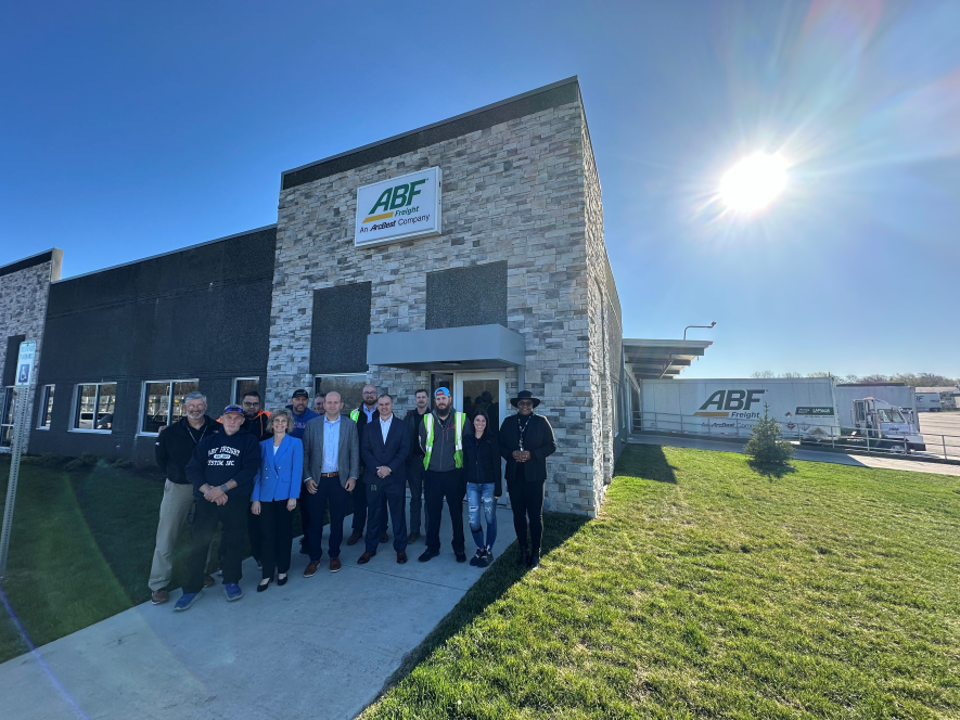 Judy McReynolds and Seth Runser join team members for a group photo in front of ABF Freight’s new service center in Olathe, KS 