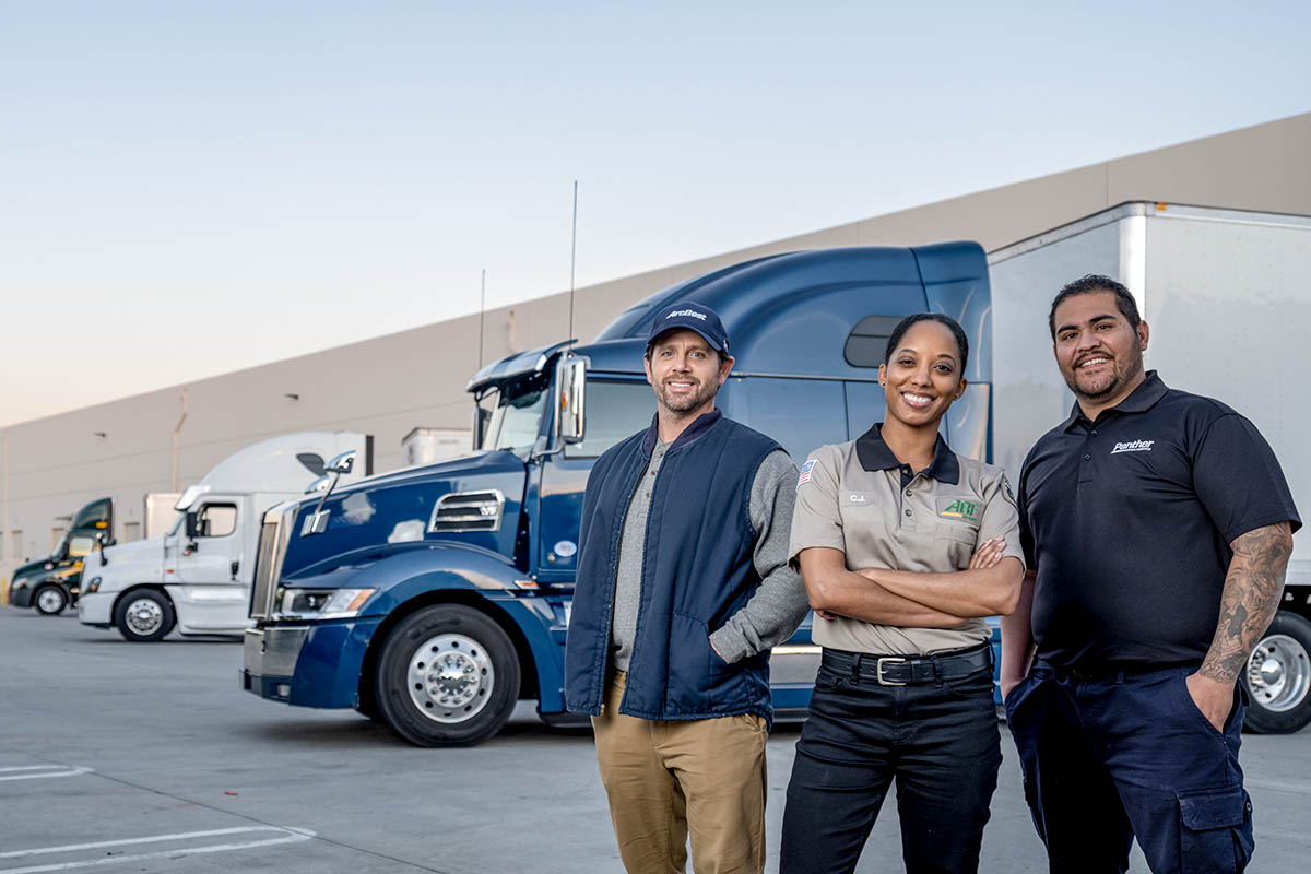 ArcBest, ABF, and Panther drivers standing in front of their trucks