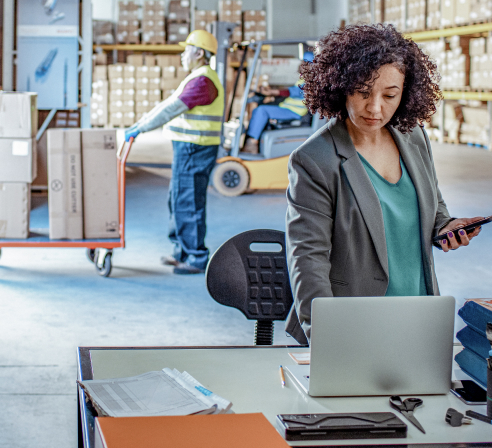 employee working on a computer in a warehouse