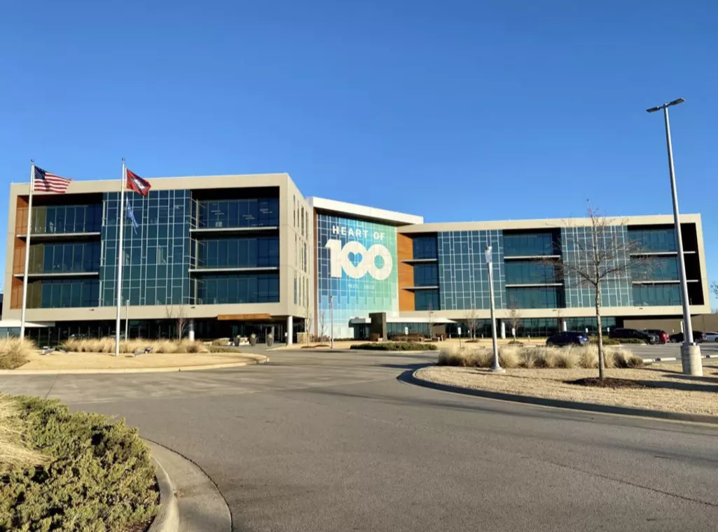 Photo of ArcBest headquarters with the Heart of 100 logo