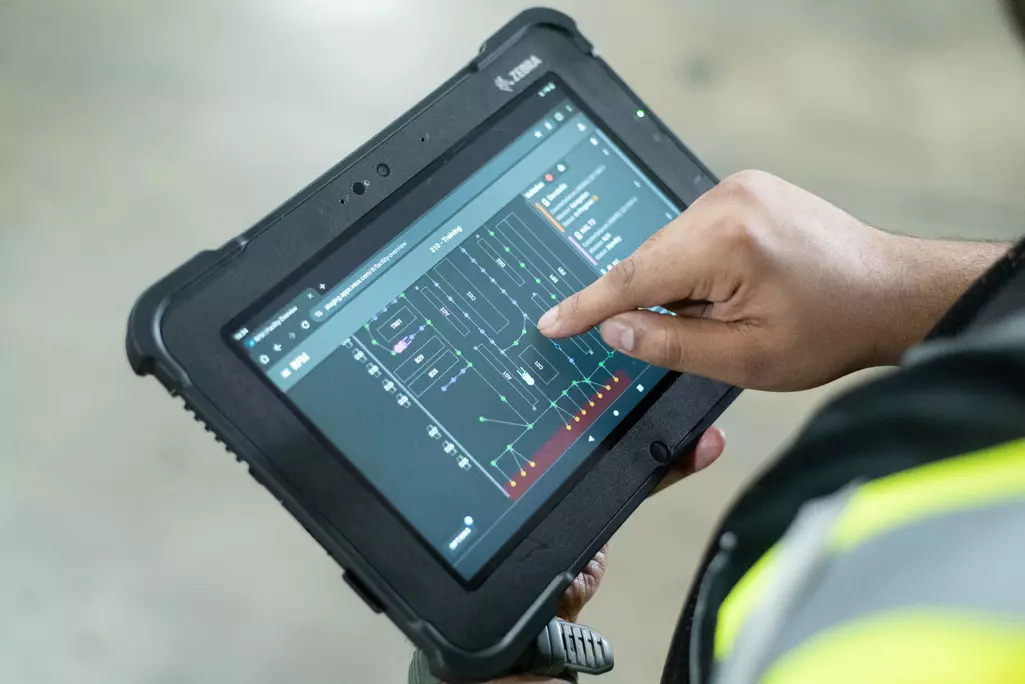 Man holding tablet showcasing Vaux Smart Autonomy