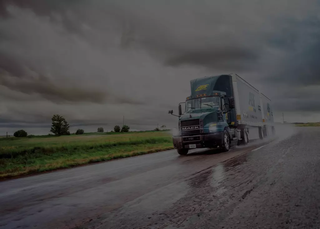 ABF truck driving down a highway in the rain