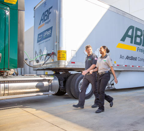 ABF employees walking around an ABF semi truck