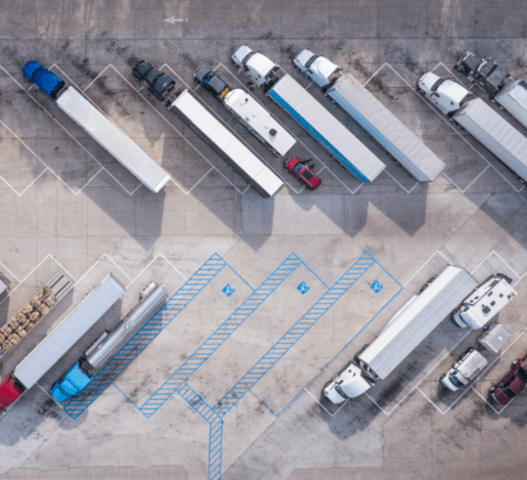 parked semi-trucks in a parking lot