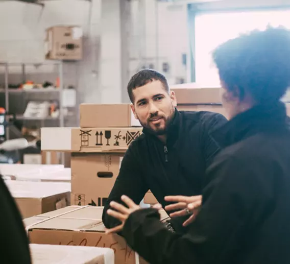 Employees talking in a warehouse