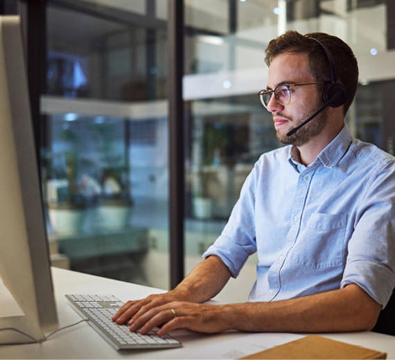 Freight brokerage representative assisting a customer over the phone.