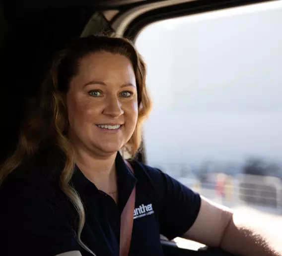 Woman sitting in the driver seat of a Panther truck. 