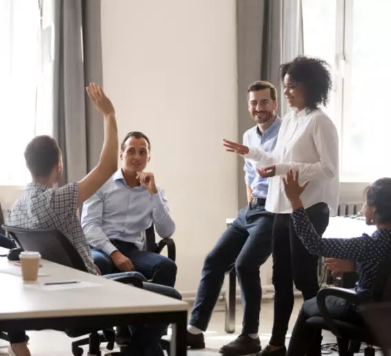 Group of people sitting and standing during a business meeting. 