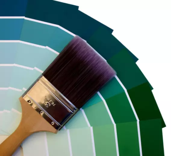 Paintbrush and a fan of paint color swatches.