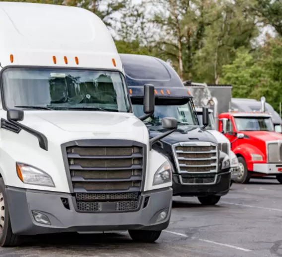 Semi-trucks parked in a lot.