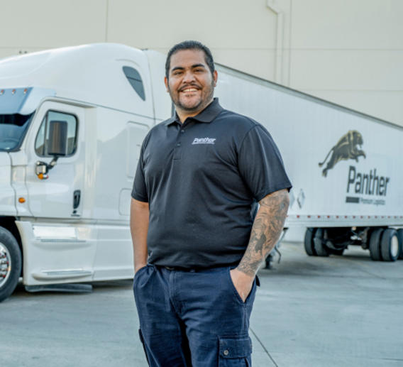 Panther employee standing in front of semi-truck