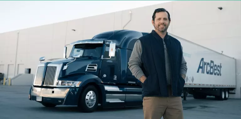 dedicated driver standing in front of a truck