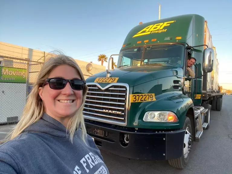 [Brianna Wasko] Brianna Wasko, the first female named to the 2023-2024 ABF Road Team, poses outside an ABF truck. 