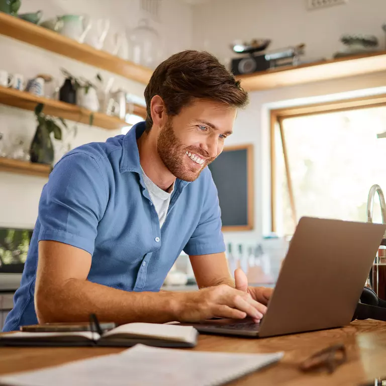 Man on computer scheduling residential delivery 