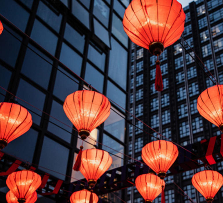 Red paper lanterns hang outside a building during Lunar New Year.