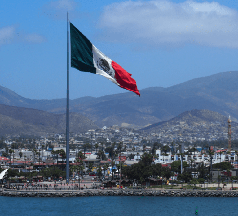 Mexico’s flag flying on the shoreline between the U.S. and Mexico