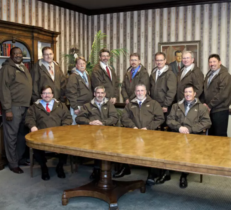 Twelve men in ABF jackets.