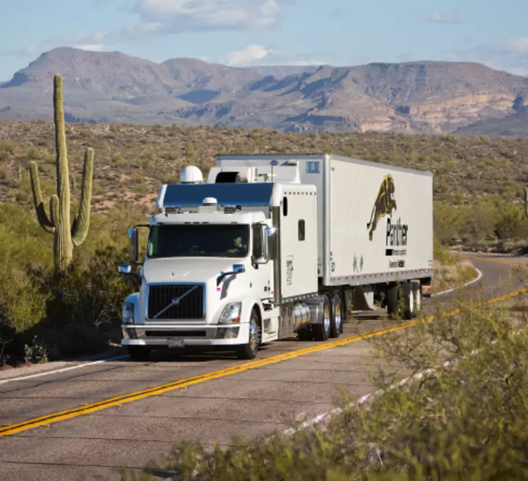 Panther truck driving on mountain highway.