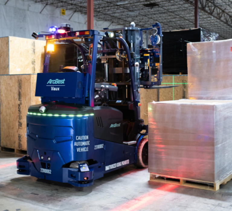 Vaux Smart Autonomy forklift next to pallets in a warehouse.