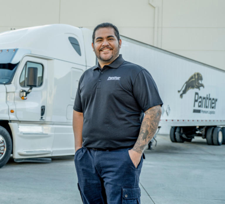 Panther employee standing in front of semi-truck