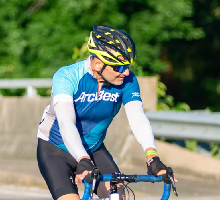 Cyclist wearing ArcBest cycling gear and riding a bike