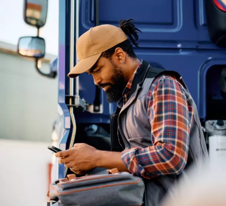 ArcBest employee standing behind truck