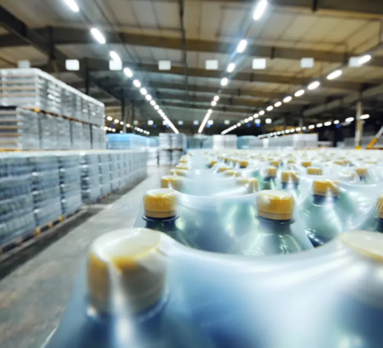 Pallets of bottled beverages in a warehouse.