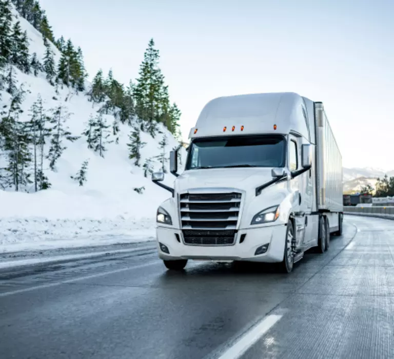 Winterproof truck driving on an icy road