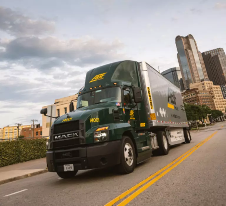 ABF Freight LTL truck driving down a city street.