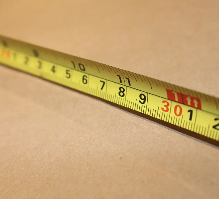 Tape measure being used to measure a box.