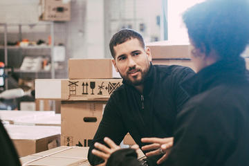 Employees talking in a warehouse