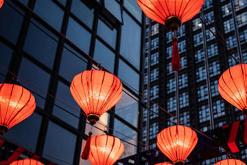 Red paper lanterns hang outside a building during Lunar New Year.