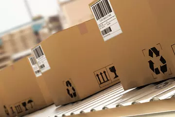 Boxes on a conveyer belt getting ready to be shipped.