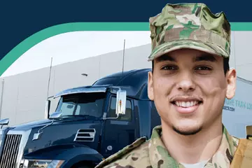 Male Service Member in uniform standing in front of an ArcBest semi truck.