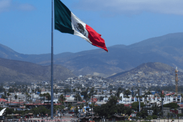 Mexico’s flag flying on the shoreline between the U.S. and Mexico