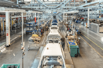 Cars being built on a production line using JIT inventory