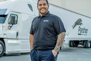 Panther employee standing in front of semi-truck