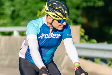 Cyclist wearing ArcBest cycling gear and riding a bike