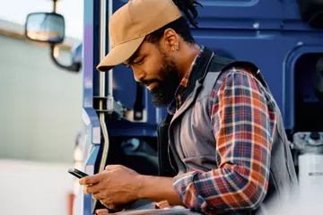 ArcBest employee standing behind truck