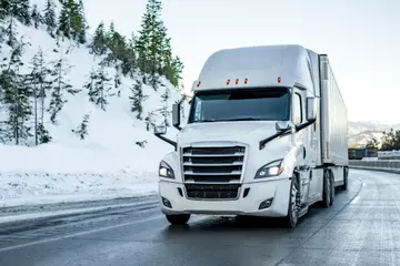 Winterproof truck driving on an icy road