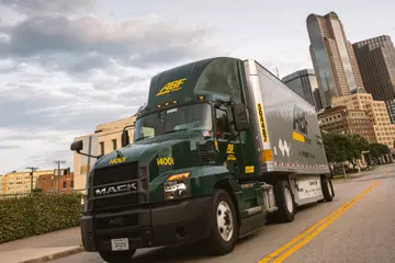 ABF Freight LTL truck driving down a city street.