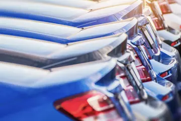 Line of cars in a parking lot.