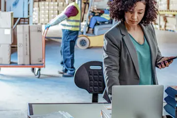 employee working on a computer in a warehouse