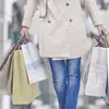 Woman carrying holiday shopping bags.